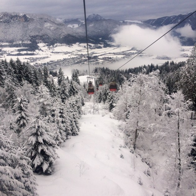 uitzicht vanuit de gondel op de besneeuwde afdaling eronder